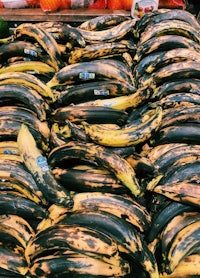 a bunch of bananas on a table at a market