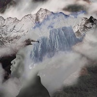 a man in front of a mountain with clouds in the background