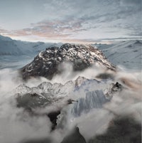 an image of a mountain covered in clouds